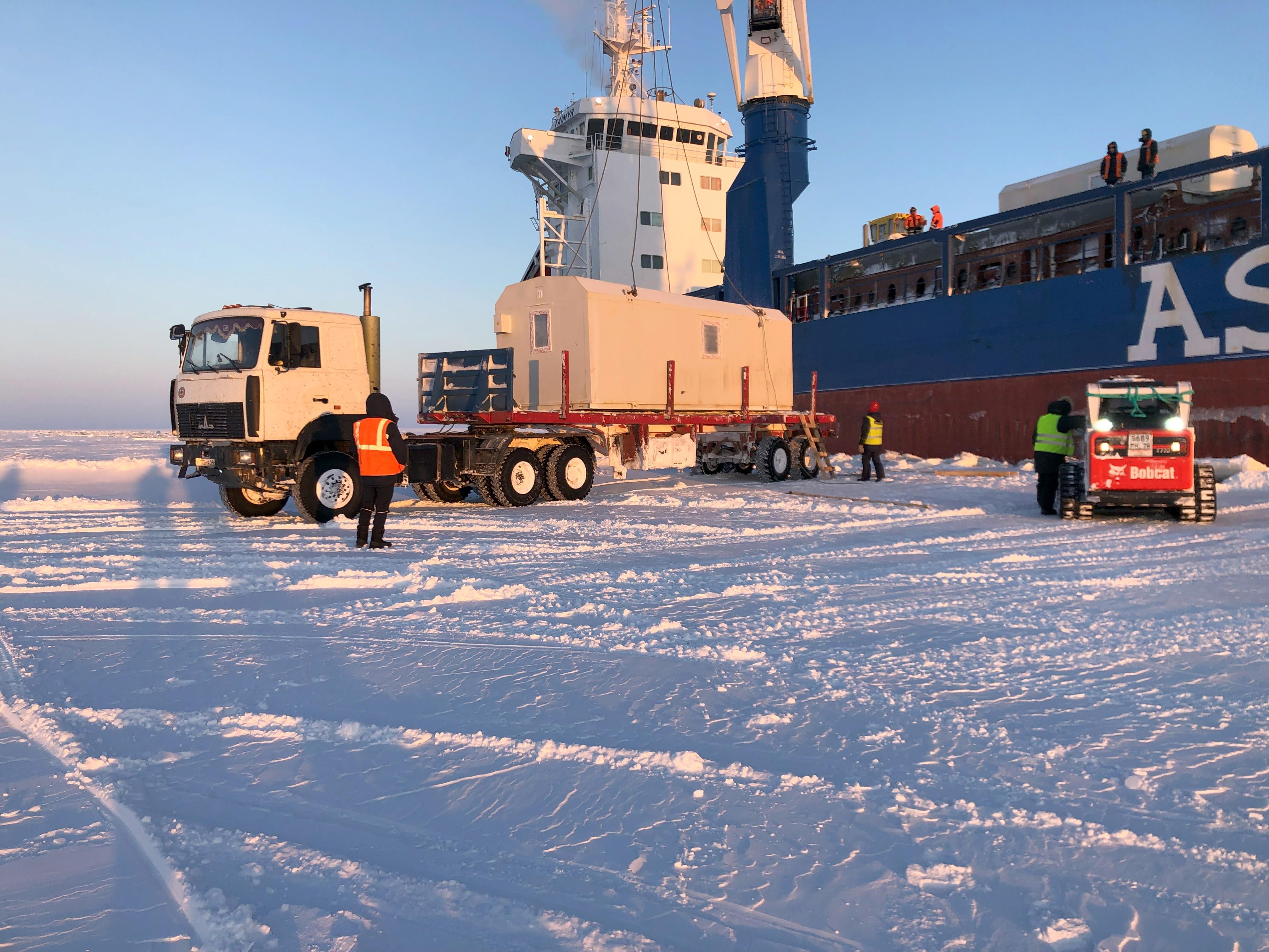 View of containers in motion at a large logistics hub located in a port.
